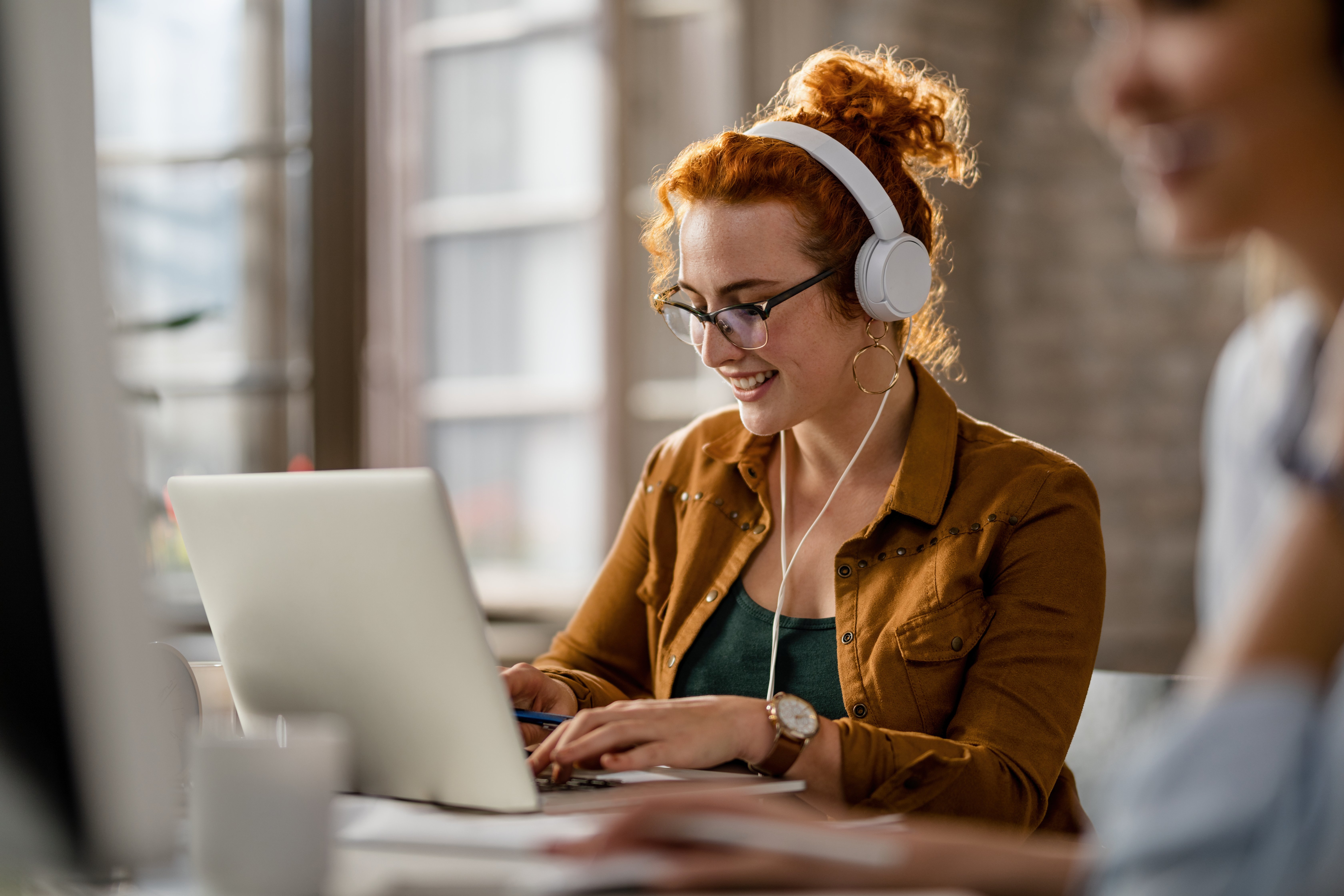 happy-freelance-worker-working-on-laptop-while-wea-2022-09-23-23-11-43-utc