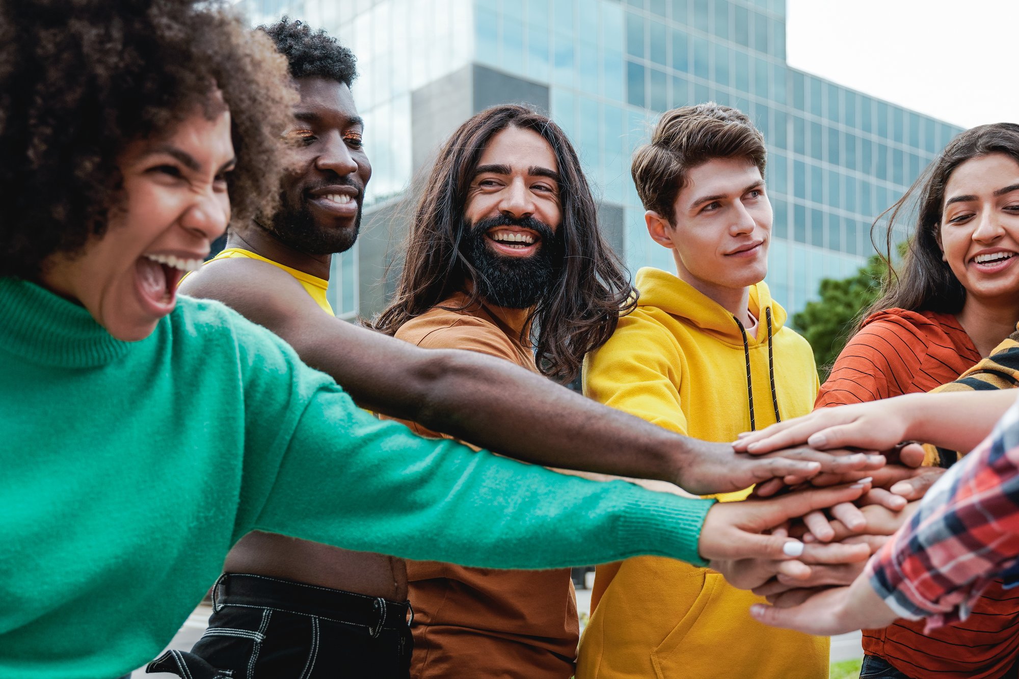 young-diverse-group-of-people-stacking-hands-toget-2022-08-26-12-31-02-utc